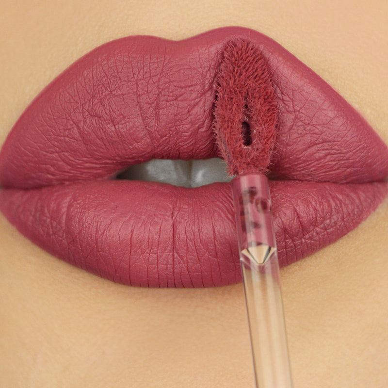 closeup of lips wearing pink liquid lipstick